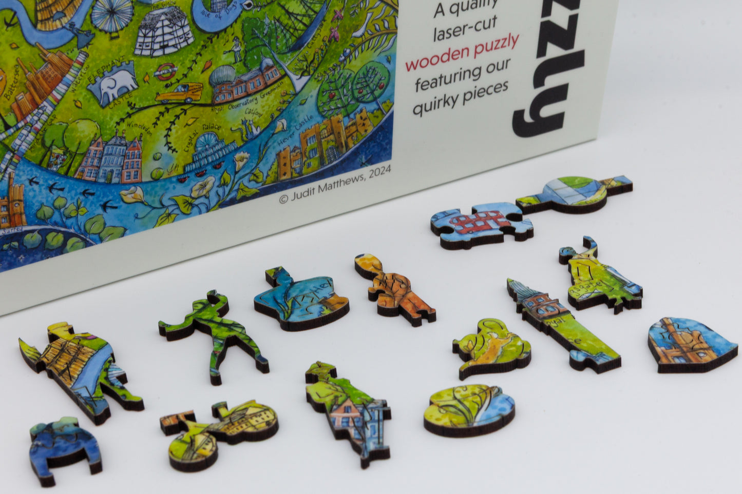 London Wooden Jigsaw Puzzle with London themed whimsical pieces. Artwork by Judit Matthews. Made in Britain. 638 or 216 pieces.