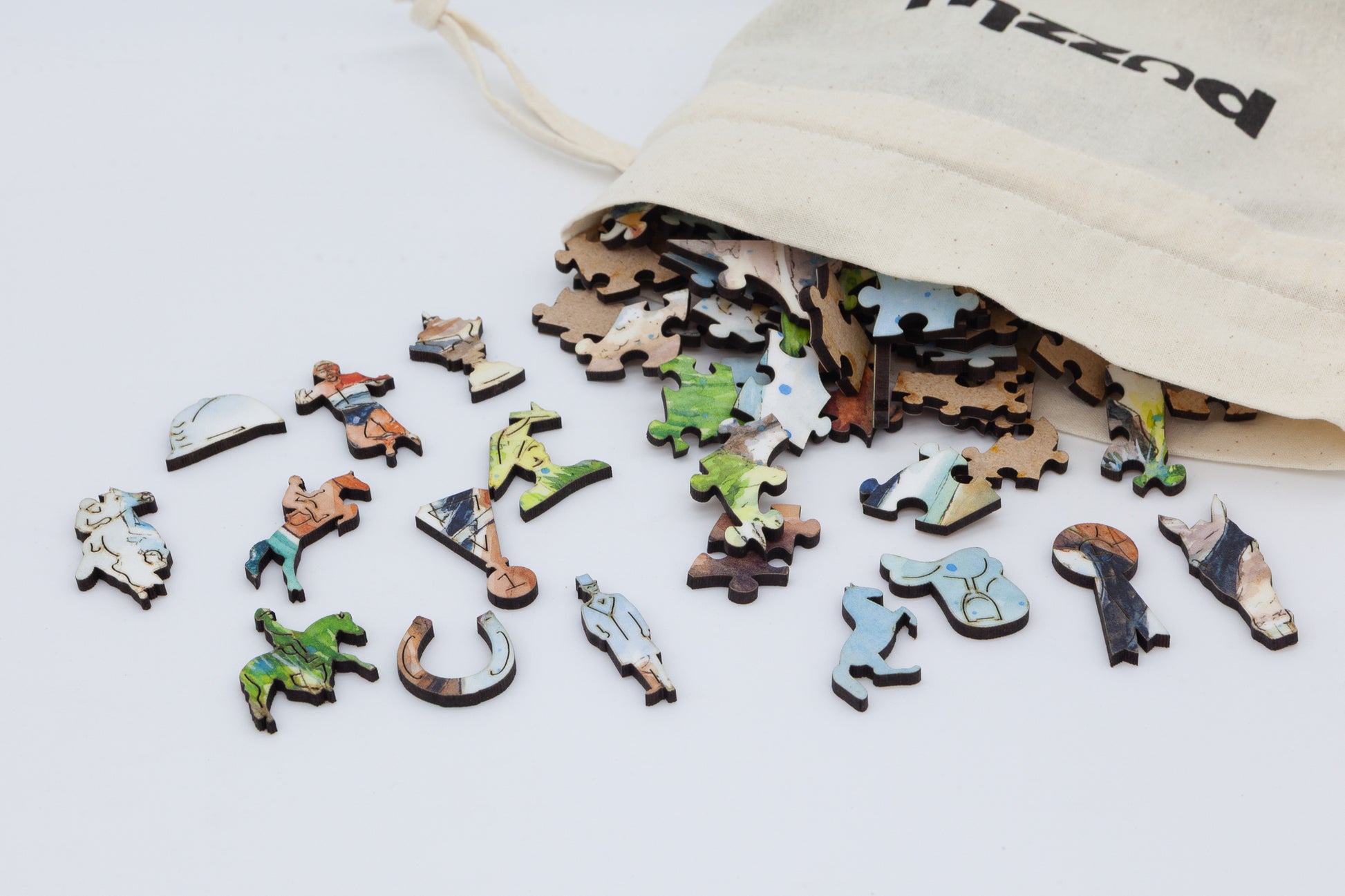 The Horse Race Wooden Jigsaw Puzzle by The Puzzly Company.  Artwork by June Lloyd.  A fun filled puzzle with regular and whimsical pieces.  Made in Britain.