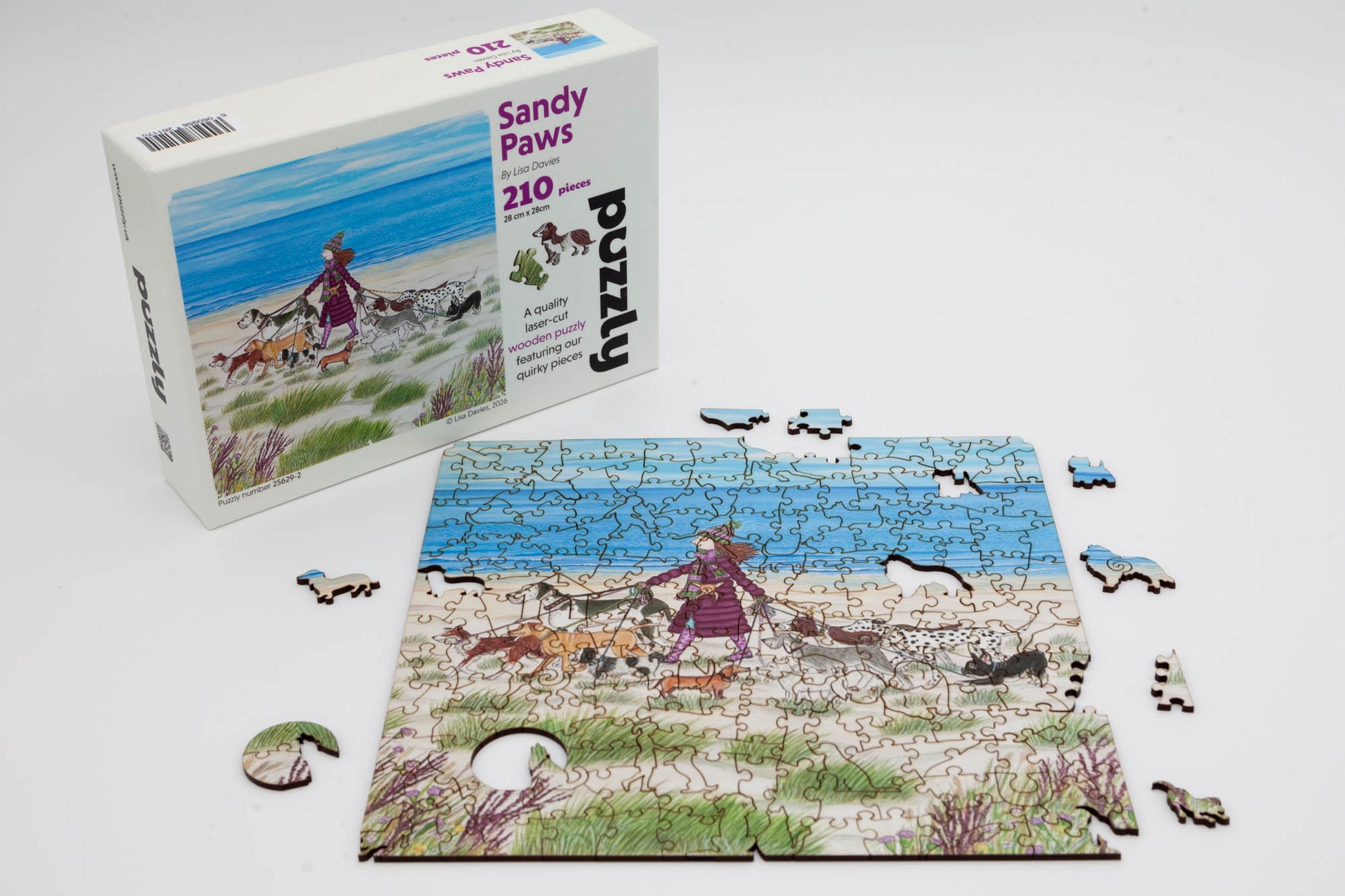Sandy Paws Wooden Jigsaw Puzzle.  Original artwork by Lisa Davies.  210 dog themed and irregular jigsaw pieces.  Made in Britain by The Puzzly Company.